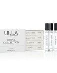 A luxurious box containing the UULA Travel Collection, showcasing four 10 ml fragrances. The collection is described as a perfume passport with scents for various occasions, including exotic sunsets, sophisticated evenings, starlit adventures, and joyous moments. The image conveys elegance and versatility.