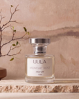 Midnight Rose 50ml parfum styled on travertine against a warm plaster wall